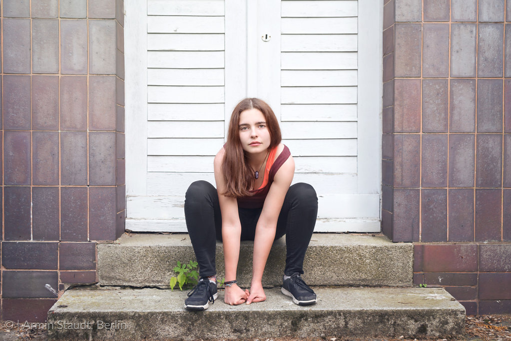 portrait of a cool young woman sitting on stairs