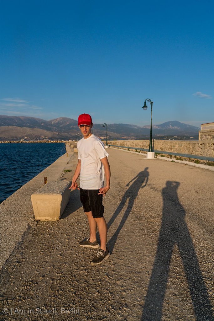 young man on vacation with the shadow of the photographer 