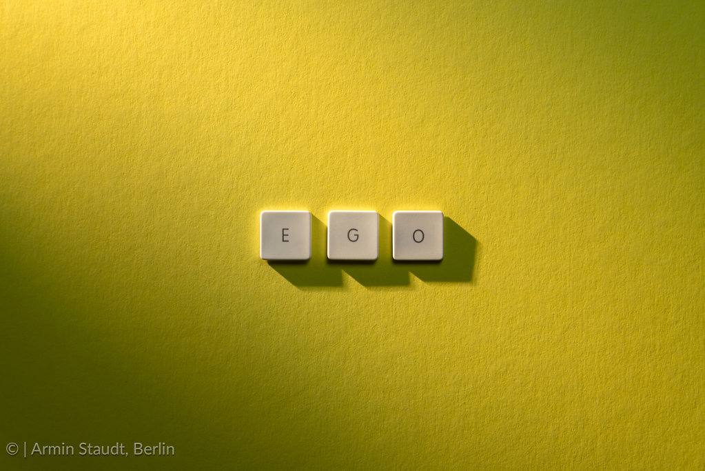 description of the word Ego on yellow background
