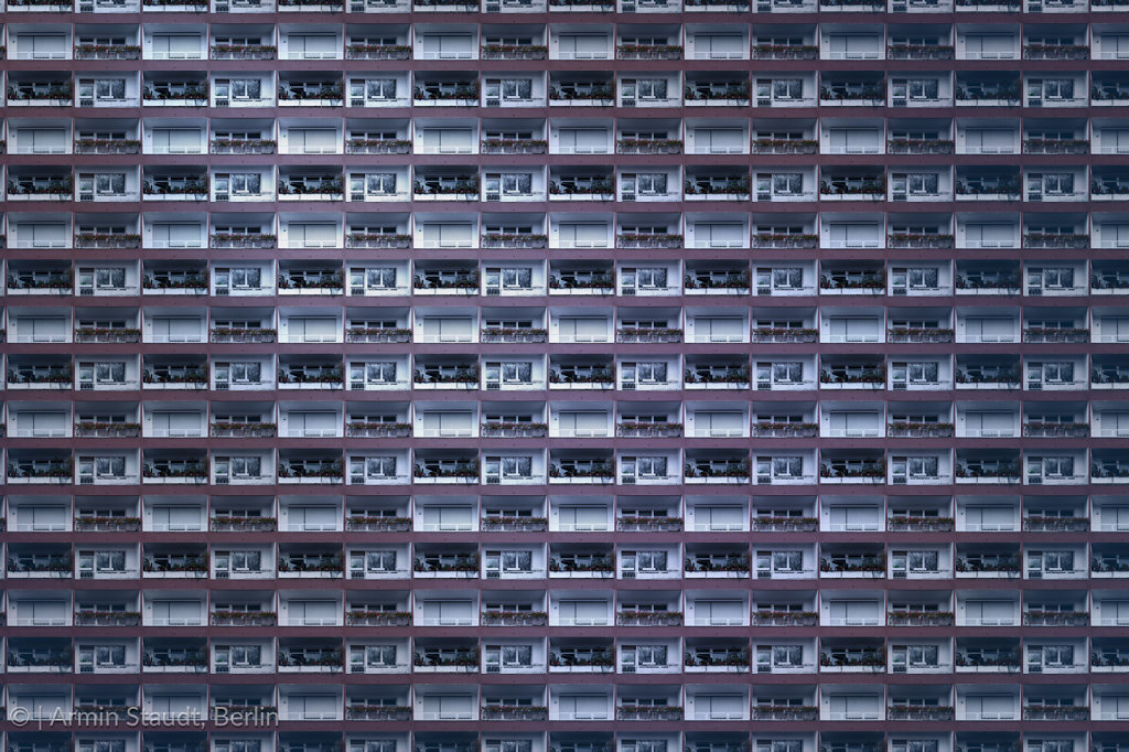 architectural pattern, dark facade with windows and balconies of a miserable berlin house